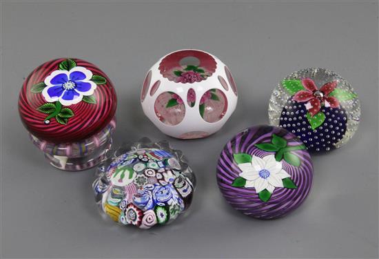 Five John Deacons glass paperweights; 7.5cm